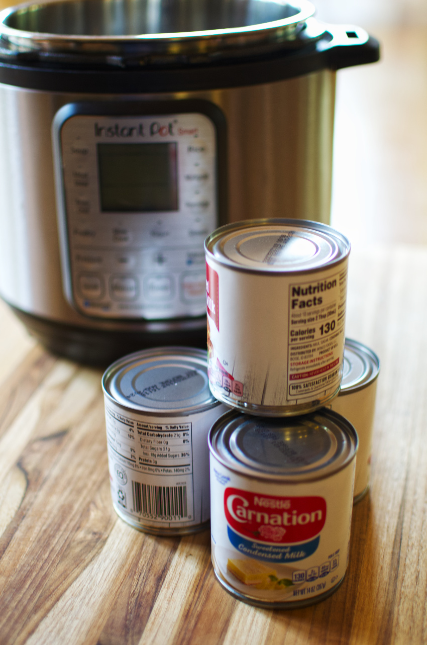 Cans of condensed milk with an Instant Pot in the background