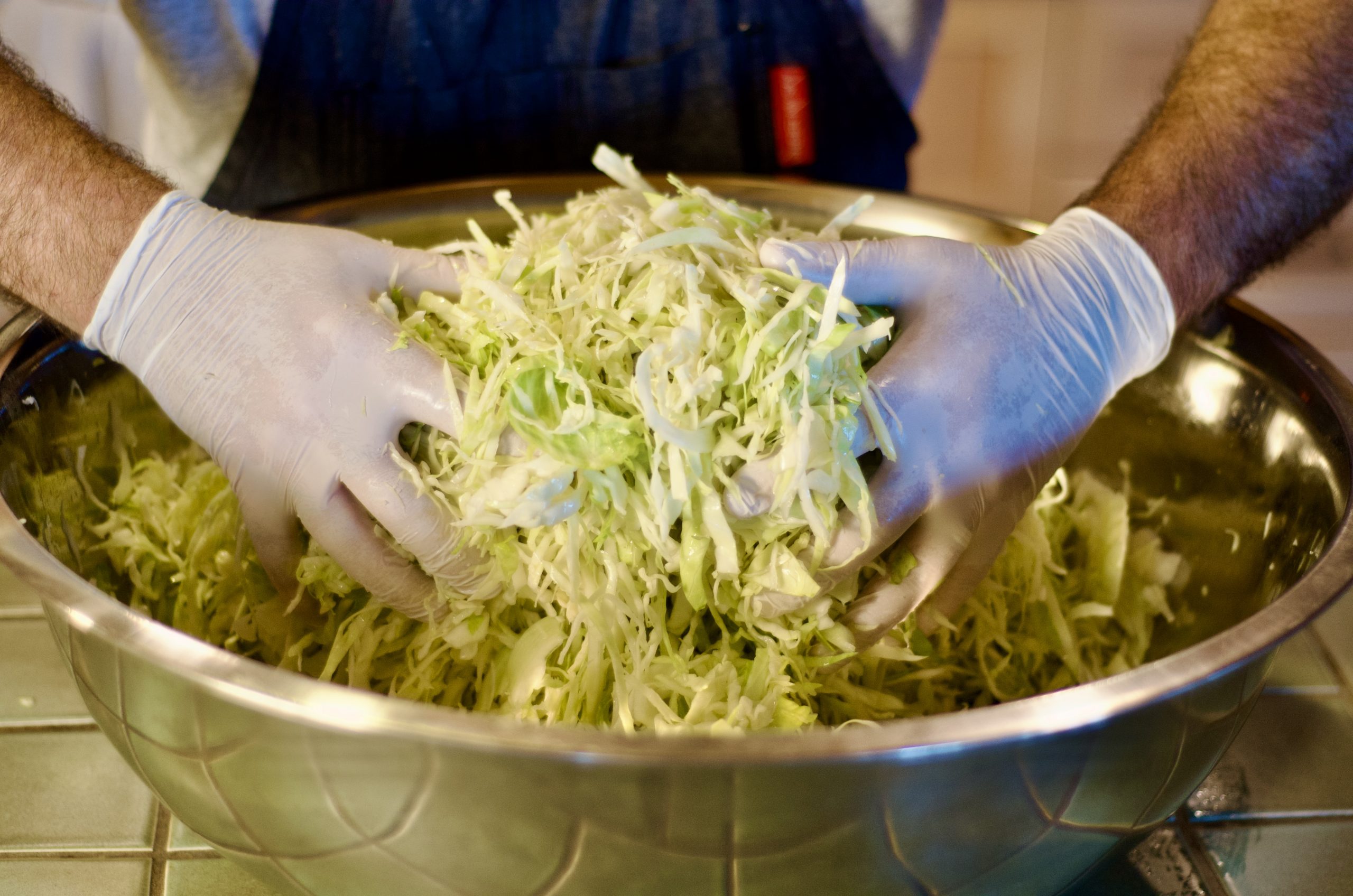 Cabbage Being Mixed with Salt