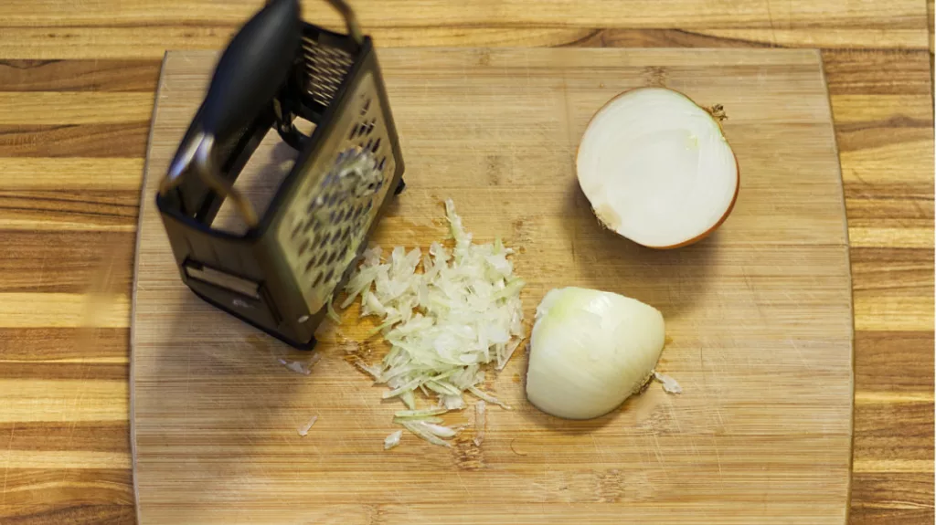 Peeled onion being grated.