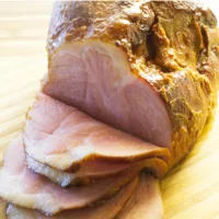 Sliced Double Smoked Ham on a board.