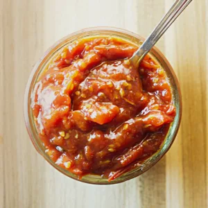 Small mason jar containing Cherry Tomato Jam.