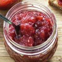 Small mason jar containing Rhubarb and Gin Jam.