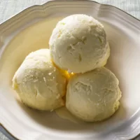 Bowl containing three scoops of Clotted Cream Ice Cream.