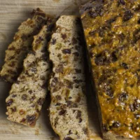 Slices of Barmbrack on a wooden board showing the inside of the bread.