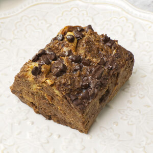 A serving of Chocolate Bread Pudding with Brioche on a white plate.