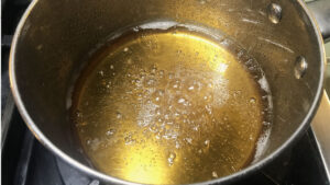 Golden Syrup simmering gently in a pot.