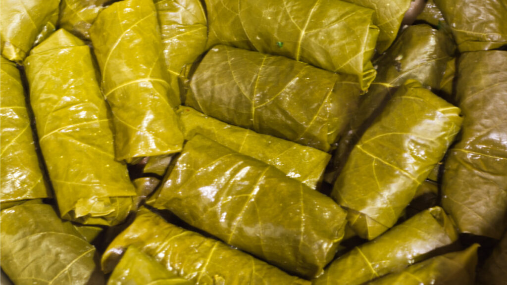 All the stuffed grape leaves in the pot ready to be cooked.